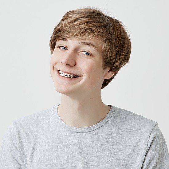 Teen boy with braces smiling