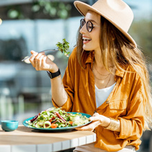 Woman smiling while eating outside