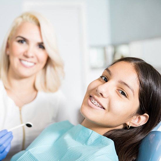 young girl sitting in orthodontic office