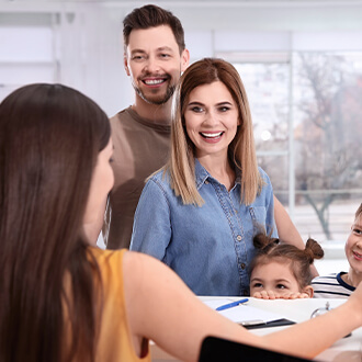 Family of three checking in at orthodontist office front desk