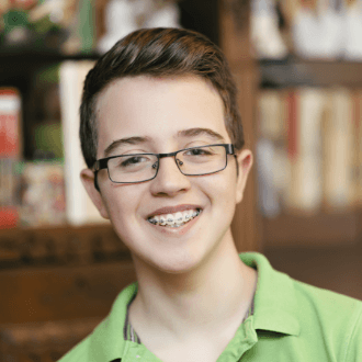 Teen boy with traditional braces smiling