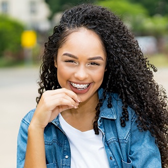 Young woman with metal braces smiling