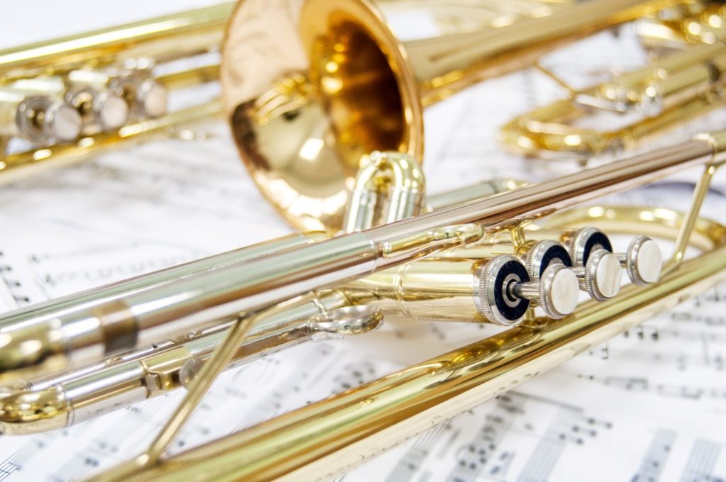 Closeup of golden trumpet lying on sheet music