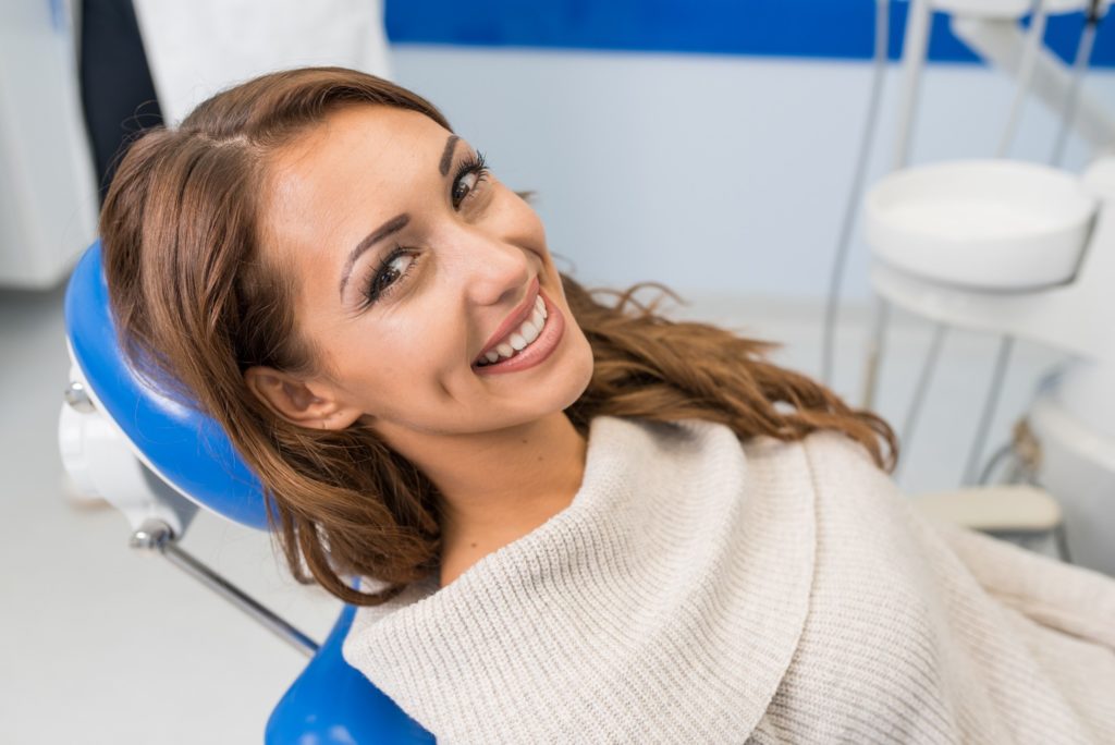 Woman smiling after getting her braces removed