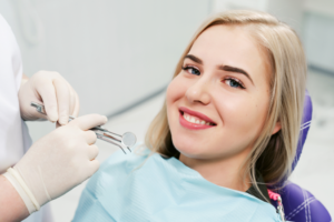 a patient smiling after having her braces removed
